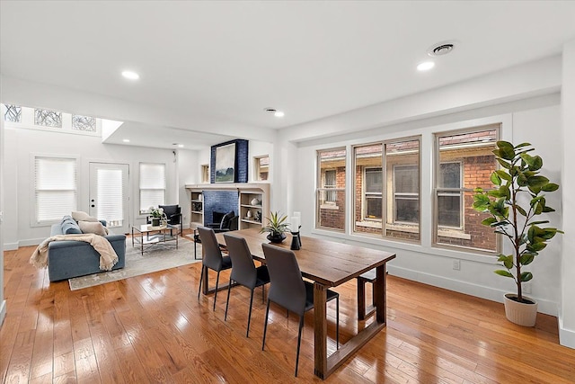 dining space with light hardwood / wood-style floors