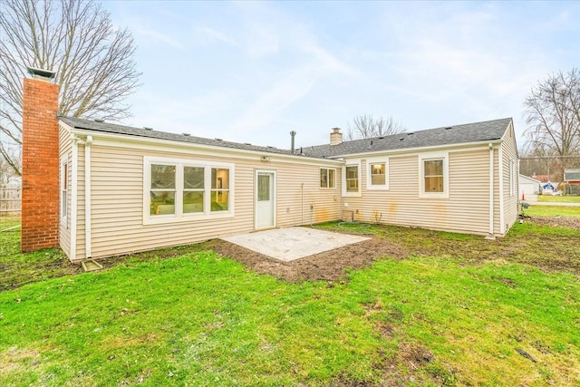 back of house with a patio area and a yard