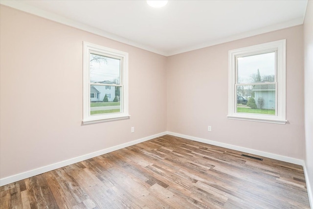 unfurnished room featuring crown molding and light hardwood / wood-style flooring