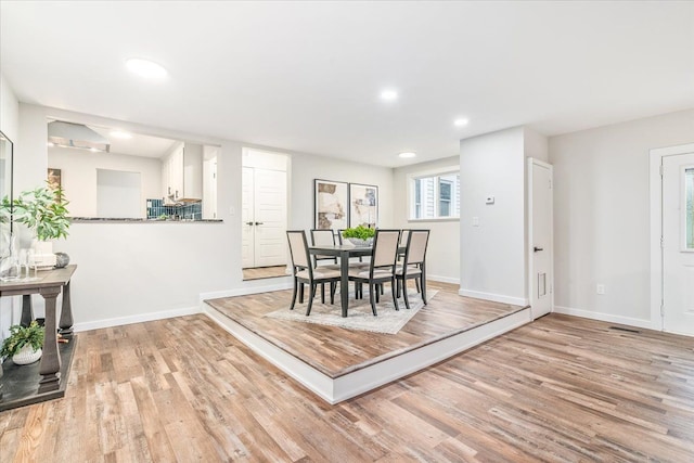 dining space featuring light wood-type flooring