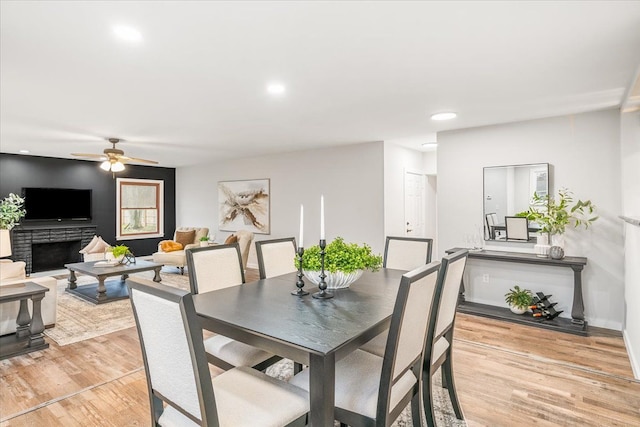 dining room with ceiling fan and light hardwood / wood-style flooring