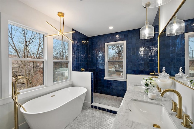 bathroom with vanity, tile patterned flooring, plus walk in shower, and an inviting chandelier