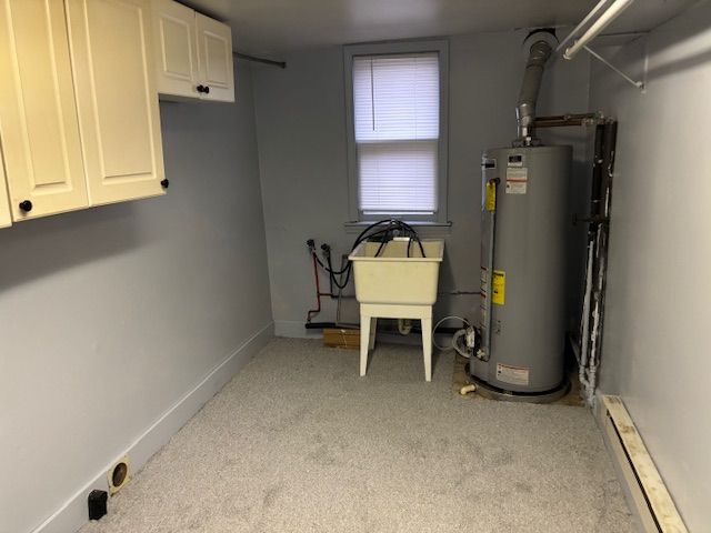 utilities featuring baseboard heating and gas water heater