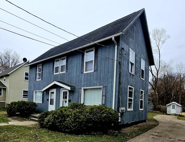 view of front of home featuring a shed