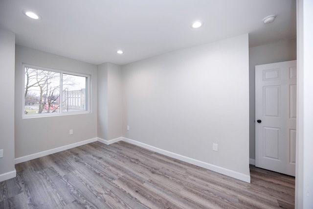 unfurnished room with light wood-type flooring