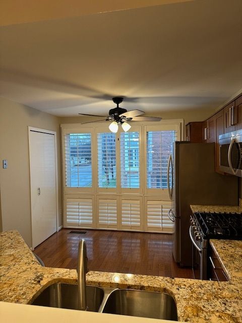 kitchen featuring dark hardwood / wood-style floors, a healthy amount of sunlight, sink, and stainless steel appliances