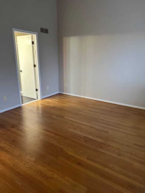 spare room with dark wood-type flooring