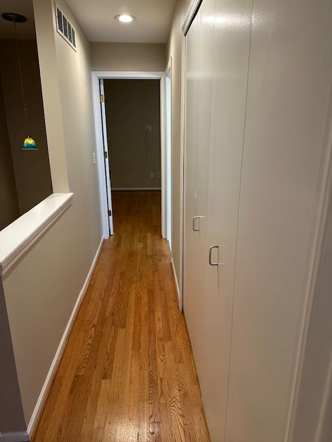 corridor with light hardwood / wood-style floors