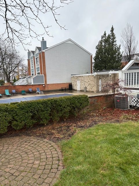 view of yard with central air condition unit and a patio