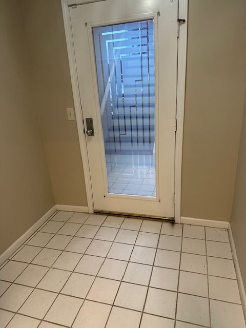 doorway featuring light tile patterned flooring