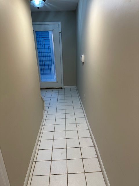 hallway with light tile patterned floors