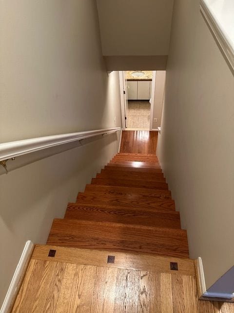 stairway featuring hardwood / wood-style flooring