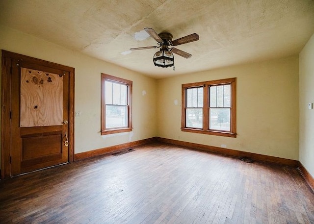 spare room featuring ceiling fan and dark hardwood / wood-style flooring