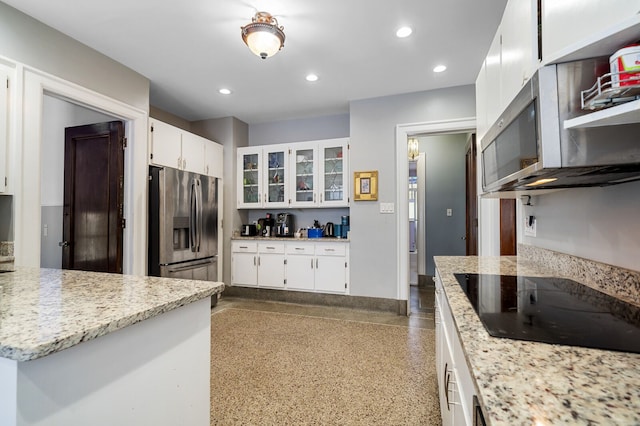 kitchen featuring white cabinets, light stone countertops, and appliances with stainless steel finishes