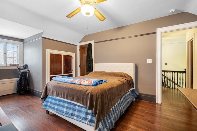 bedroom with ceiling fan, dark hardwood / wood-style floors, and lofted ceiling