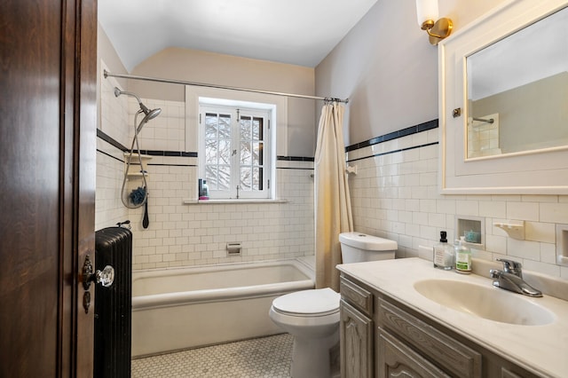 full bathroom featuring radiator heating unit, toilet, shower / tub combo with curtain, vanity, and tile walls