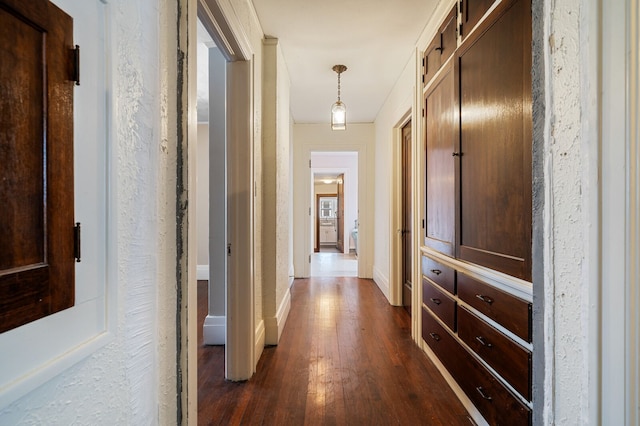 hallway with dark hardwood / wood-style floors