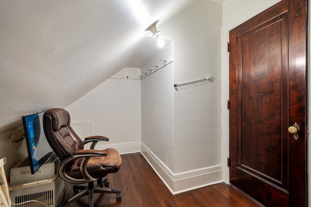 sitting room with lofted ceiling and dark wood-type flooring