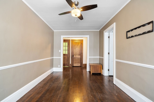 unfurnished room featuring ceiling fan, crown molding, and dark wood-type flooring