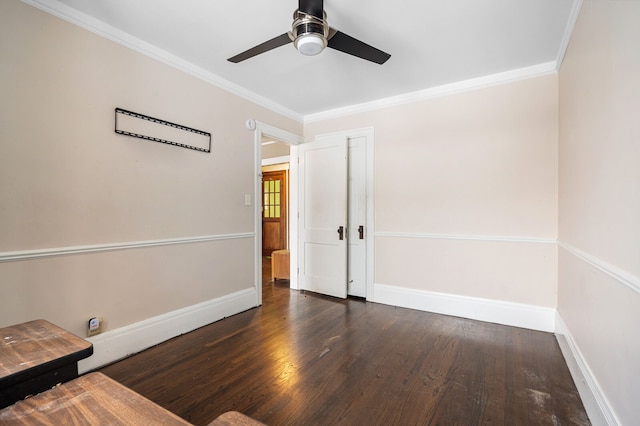 empty room featuring dark hardwood / wood-style flooring, ceiling fan, and crown molding