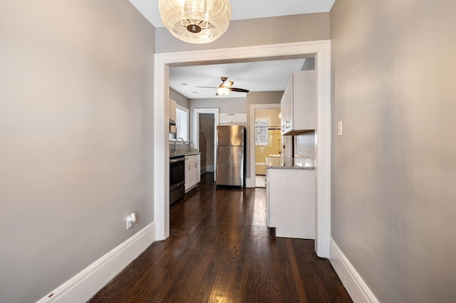 corridor featuring sink and dark wood-type flooring