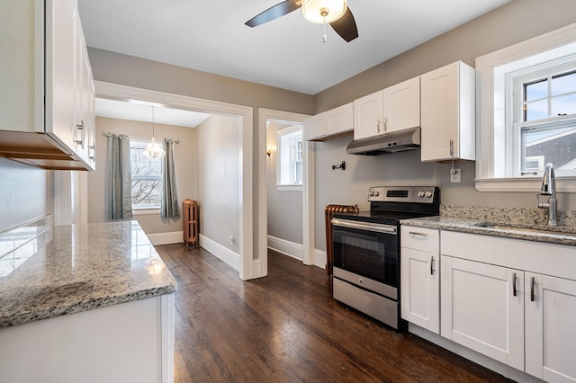 kitchen featuring stainless steel electric stove, sink, ceiling fan, decorative light fixtures, and white cabinetry