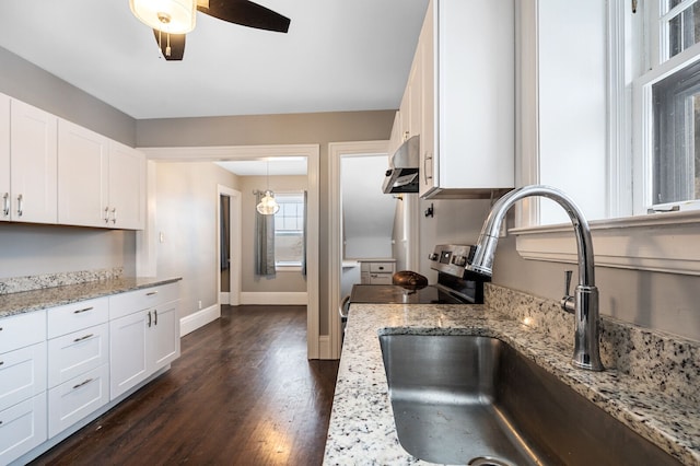 kitchen featuring light stone countertops, dark hardwood / wood-style flooring, sink, white cabinets, and stainless steel electric range oven