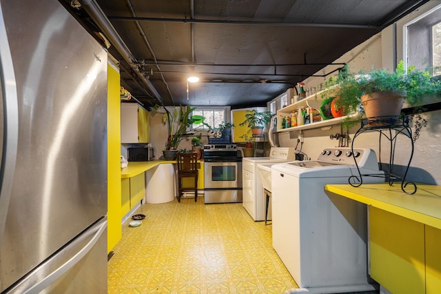 clothes washing area featuring independent washer and dryer