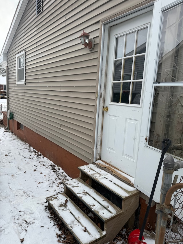 view of snow covered property entrance