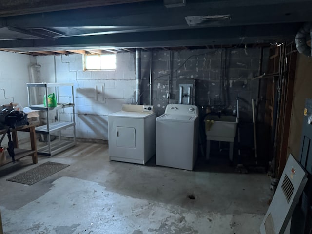 basement with sink and washer and dryer