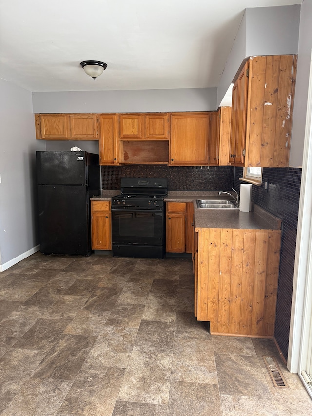 kitchen featuring kitchen peninsula, decorative backsplash, sink, and black appliances