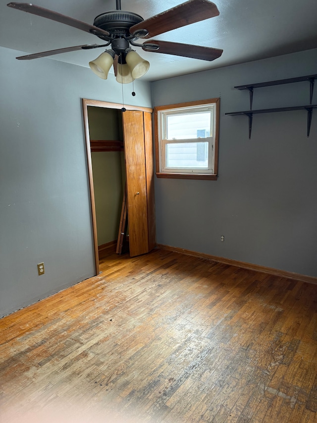 unfurnished bedroom featuring ceiling fan and light wood-type flooring