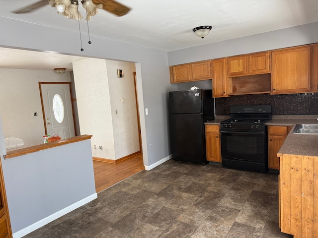 kitchen with black appliances, decorative backsplash, ceiling fan, and sink