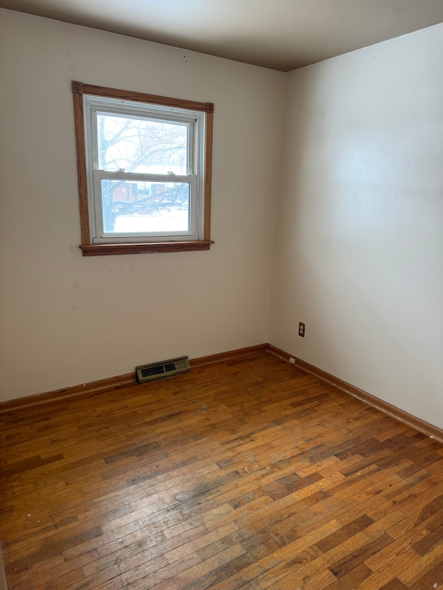 spare room with dark hardwood / wood-style floors