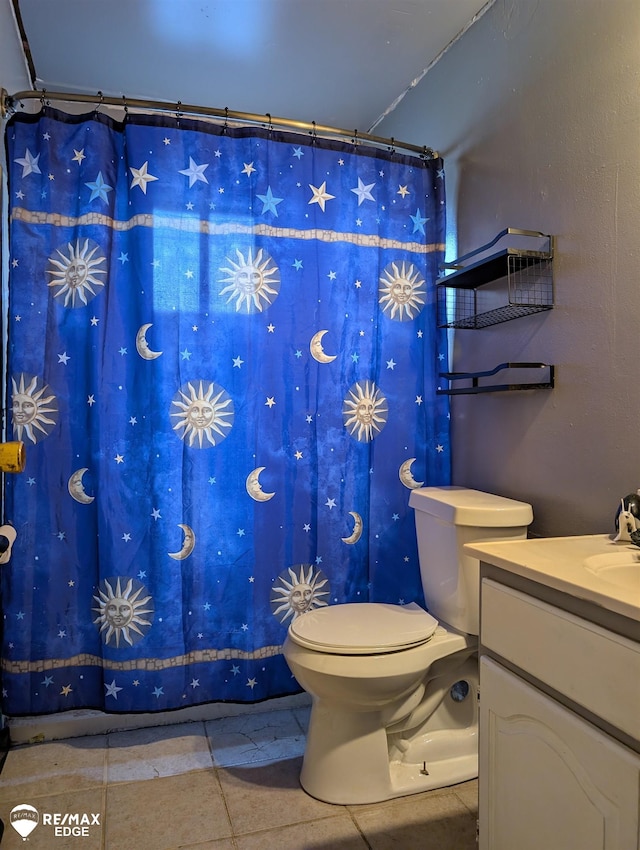 bathroom with tile patterned floors, vanity, and toilet