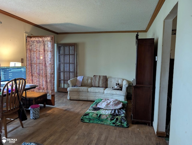 living room featuring a textured ceiling, hardwood / wood-style flooring, and crown molding