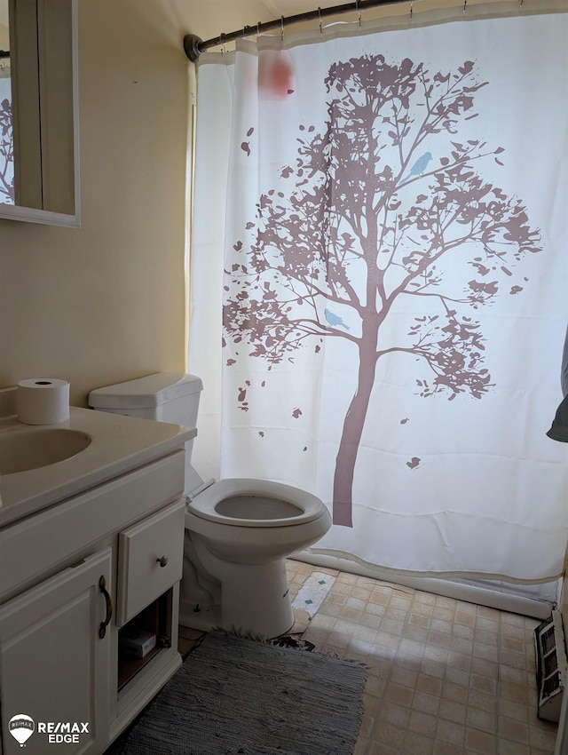 bathroom featuring vanity and toilet