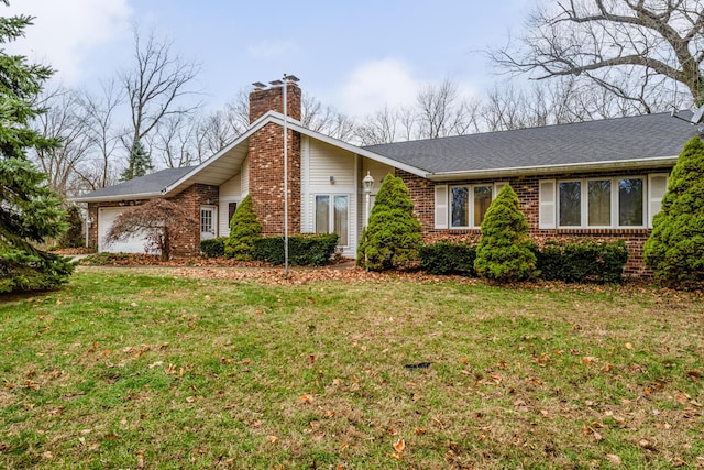 view of front of house with a garage and a front lawn