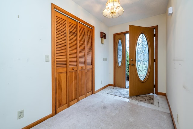 entrance foyer with light tile patterned floors and a notable chandelier