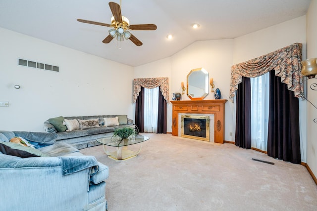 carpeted living room featuring ceiling fan and lofted ceiling