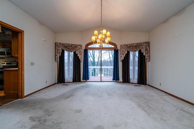 spare room with vaulted ceiling, carpet floors, and an inviting chandelier