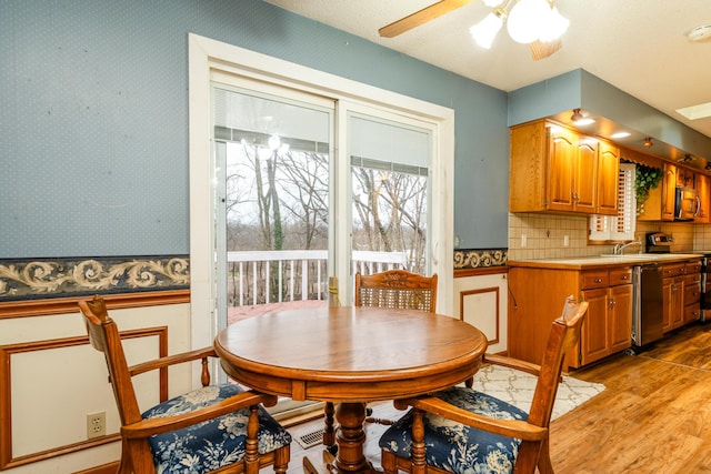 dining space featuring ceiling fan and light hardwood / wood-style flooring