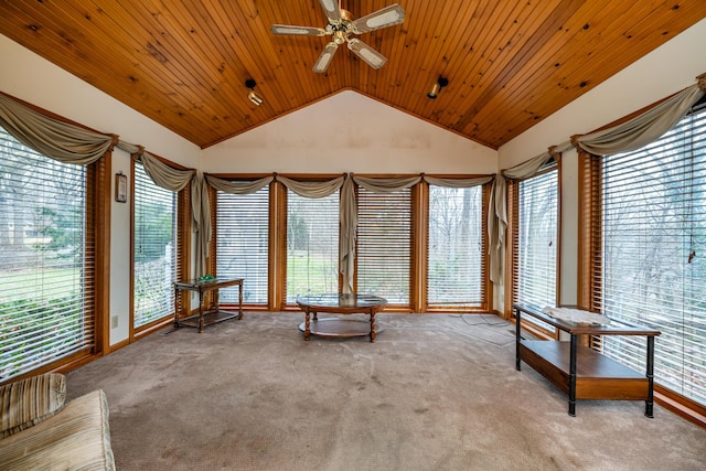 unfurnished sunroom with ceiling fan, wood ceiling, a wealth of natural light, and vaulted ceiling