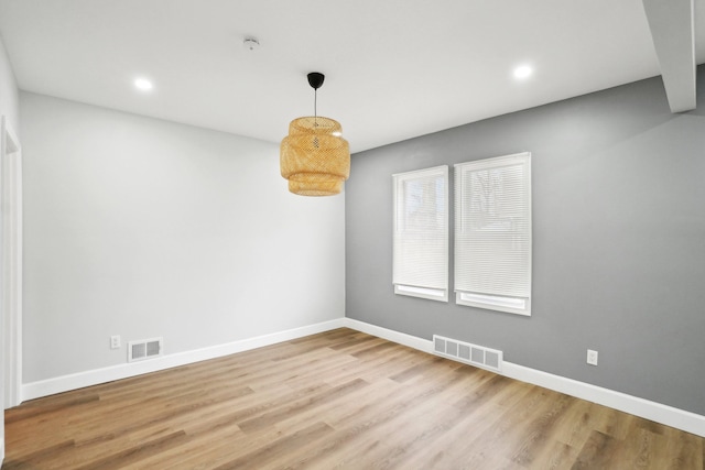 spare room featuring wood-type flooring