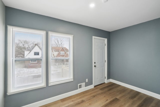 spare room featuring hardwood / wood-style floors