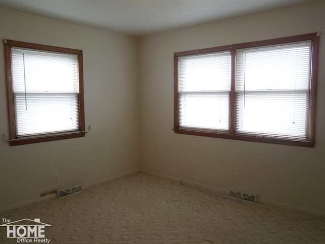 unfurnished room featuring dark colored carpet