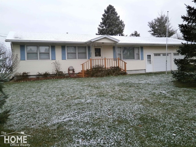 ranch-style house with a garage and a front lawn