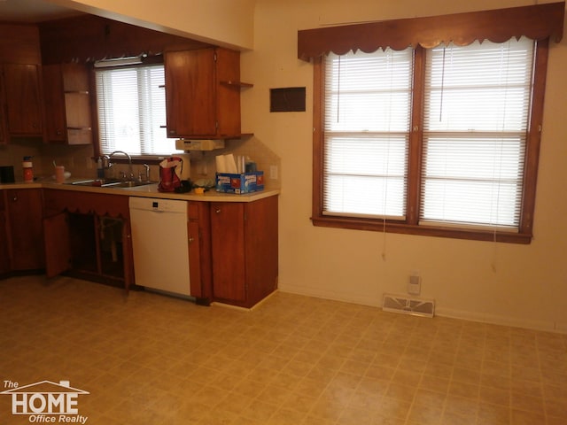 kitchen featuring white dishwasher and sink