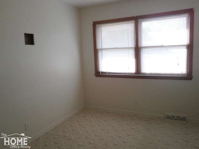 carpeted empty room with a healthy amount of sunlight