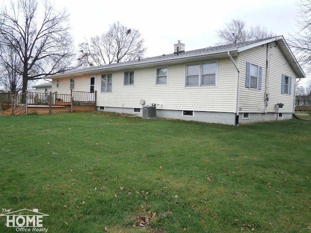 rear view of property with a lawn, cooling unit, and a wooden deck